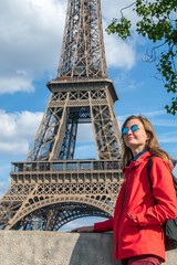 Young caucasian blond woman with Eifel tower on the background, Paris, France