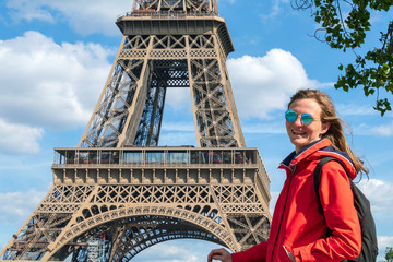 Young caucasian blond woman with Eifel tower on the background, Paris, France