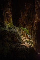 Tourist exploring Cave near the Tararak Waterfall Trail