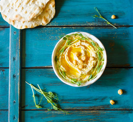 Hummus with olive oil and sprouts