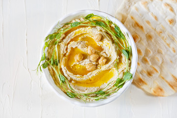 Hummus with olive oil and sprouts