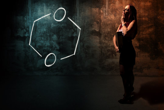 Sexy girl or secretary or female student presenting handdrawn chemical formula of Dioxane