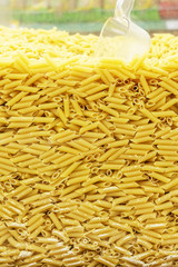 Pasta Vermicelli pasta texture background. filmed in store. scoop for bulk materials. self-service point.