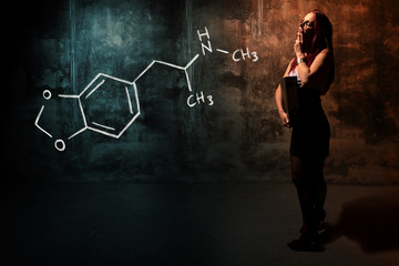 Sexy girl or secretary or female student presenting handdrawn chemical formula o MDMA ecstasy