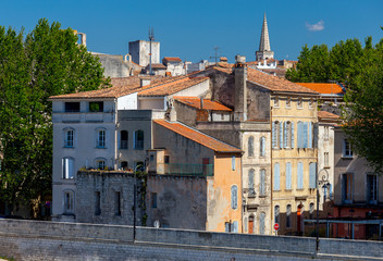 Arles. City embankment and facades of old houses.