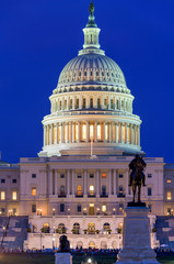 Obraz premium The Capitol at Night - A close-up view of west front of the U.S. Capitol Building, against a clear blue Summer night sky, Washington, D.C., USA. No recognizable trademark, logo or person in the image.