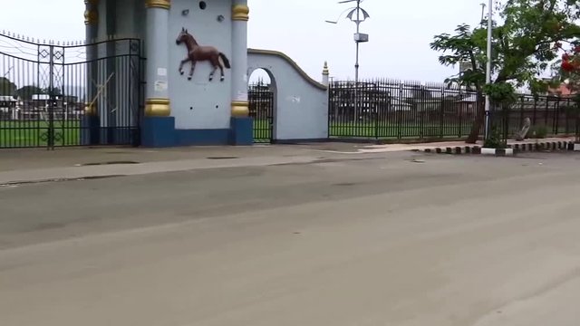 Car POV, gate and fence of the Royal Palace, Imphal, India