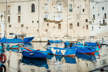 Fototapeta na wymiar Monopoli, Puglia Italy - Thursday 22 August 2019: Boats moored at the old port of Monopoli, Puglia Italy