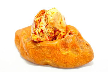 Two different pieces of amber on a white background. Natural texture of petrified resin of fossil trees. Sun stone. Pieces of natural mineral. Material for jewelers. Crystal. Amber shape and color