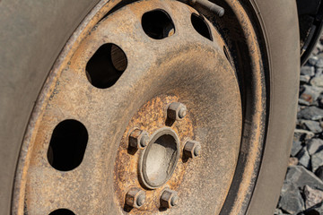 Old rusty steel auto wheel disc, car service.