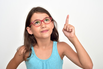 Thoughtful smiling young girl wearing glasses with index finger up having a good idea