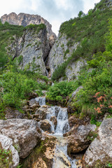 Fototapeta na wymiar View of waterfall Pisciadu (Cascate del Pisciadù) Italian Dolomites, Corvara in Badia, Italy. Summer time