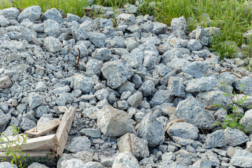Construction waste debris on an abandoned construction site, ruined demolition building concrete structures