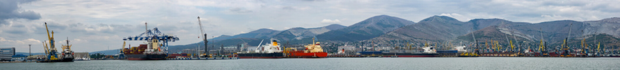 Commercial port, at the foot of the mountains, panorama - obrazy, fototapety, plakaty
