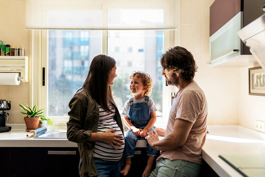 Adorable happy family playing with toys at home