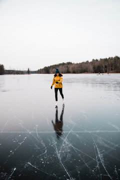 teenage girl skating on a frozen lake