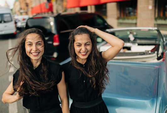 Happy young women with blue Cabriolet