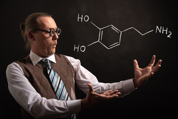 Professor presenting handdrawn chemical formula of dopamine