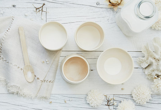 Still life of white on white ceramic dishes with milk