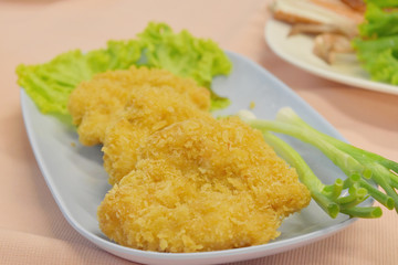 fried shrimp pancake on plate in restaurant.