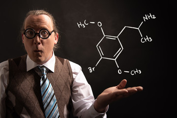 Professor presenting handdrawn chemical formula of Dimethoxybromoamphetamine dob