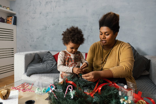 Mother and Daughter Making Christmas Decoration