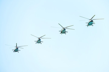 Flying military helicopters in the blue sky