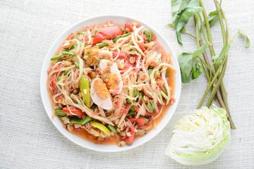 Papaya Salad with Satled Eggs, Pound chilies and garlic then place sliced tomato, eggplant and salted egg. Add fish sauce, lemon, sugar, chopped papaya then mixed all the ingredients together.