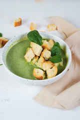 Vegetarian broccoli and spinach soup with croutons. Green healthy food concept.