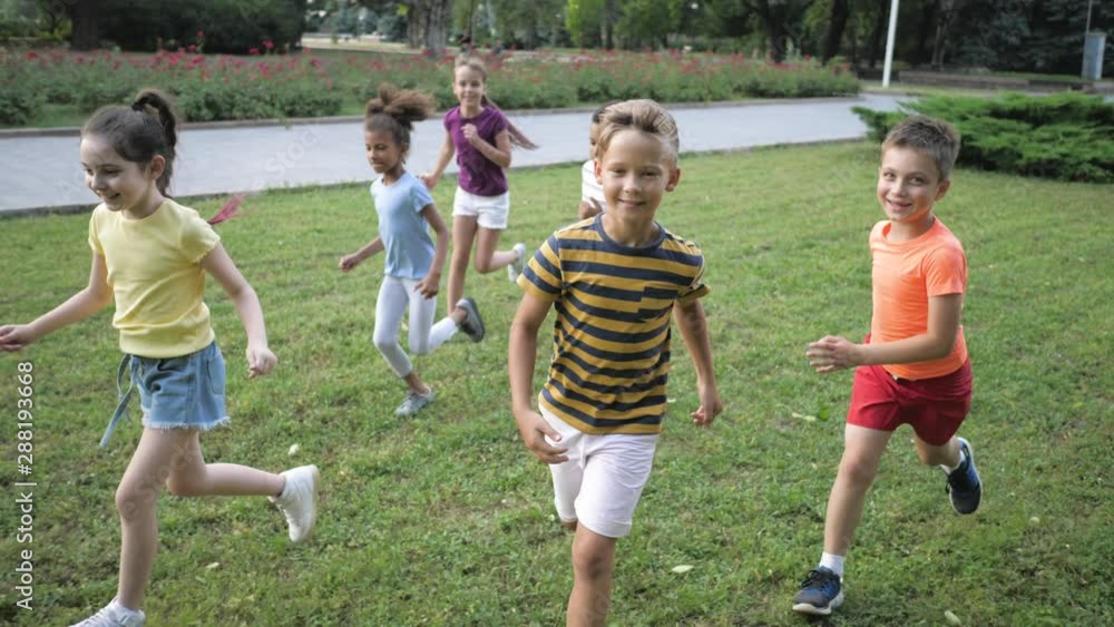 Sticker Cute smiling little children playing in park, slow motion