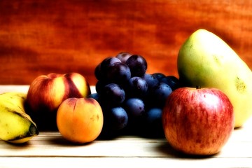 Naklejka na ściany i meble Seasonal fruits, grapes, apple, banana, peach and mango, placed on a wooden table, with a blur filter
