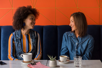 Two Women Talking At The Cafe