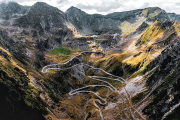 Aerial top down view of serpentine narrow road. A road full of twists and turns winding.