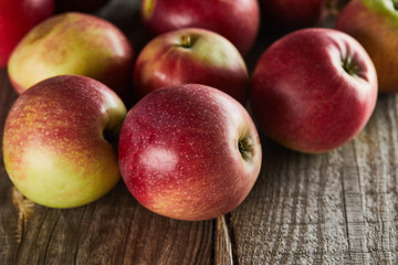 ripe juicy apples on brown wooden surface