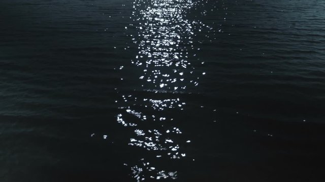 Closeup of a moonlit path on the water surface of a river. Recorded in Raw on Blackmagic camera.