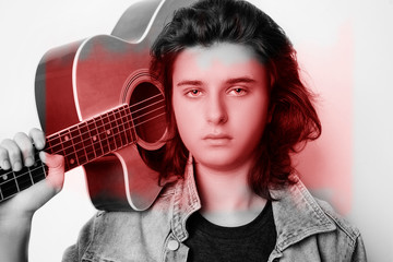 Portrait of a teenager playing guitar in studio.