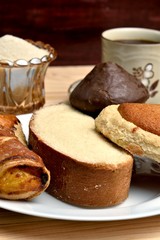 Traditional sweet bread, made with handcrafted veracruzanas, the name of the bread is chocolate pancake, pancha eye, pineapple puff pastry, butter slice, in the background a warm coffee with sugar, wo
