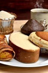 Traditional sweet bread, made with handcrafted veracruzanas, the name of the bread is chocolate pancake, pancha eye, pineapple puff pastry, butter slice, in the background a warm coffee with sugar, wo