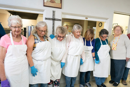 Volunteers Blessing a Community Meal