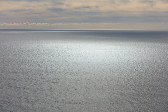 View of vast ocean, horizon and sky at dusk