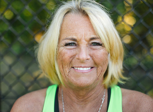 Smiling mature woman wearing tank top.