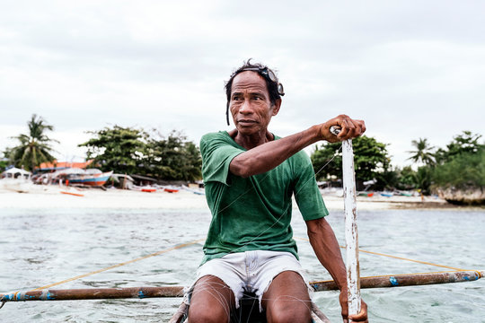 Asian man on small boat