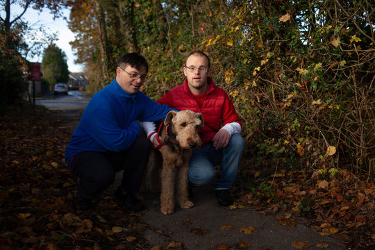 Two Men with Down Syndrome and their dog.