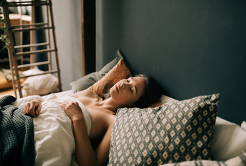 Asian Woman On The Bed