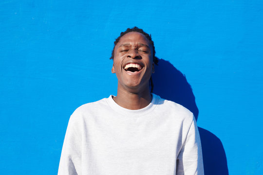 Laughing bright black man outdoors