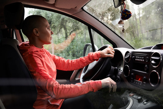 Sportswoman inside car driving forest.