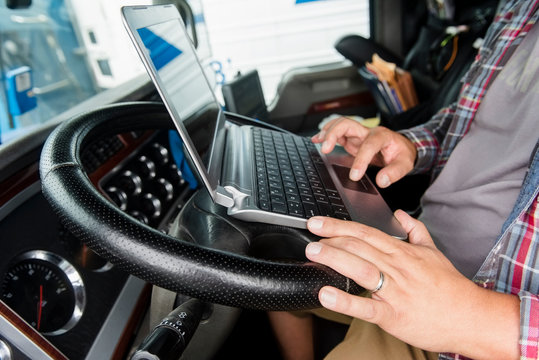 Truck driver using laptop
