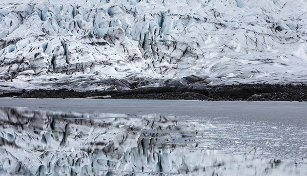 A glacier and it's reflection in still meltwater.