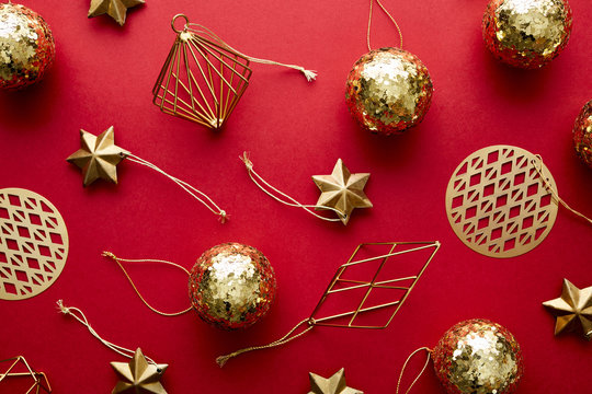 Shiny golden baubles on red background
