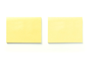 Two blank yellow sticky notes with shadow isolated on white background